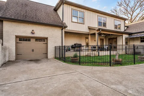 a view of a house with a small yard and fence
