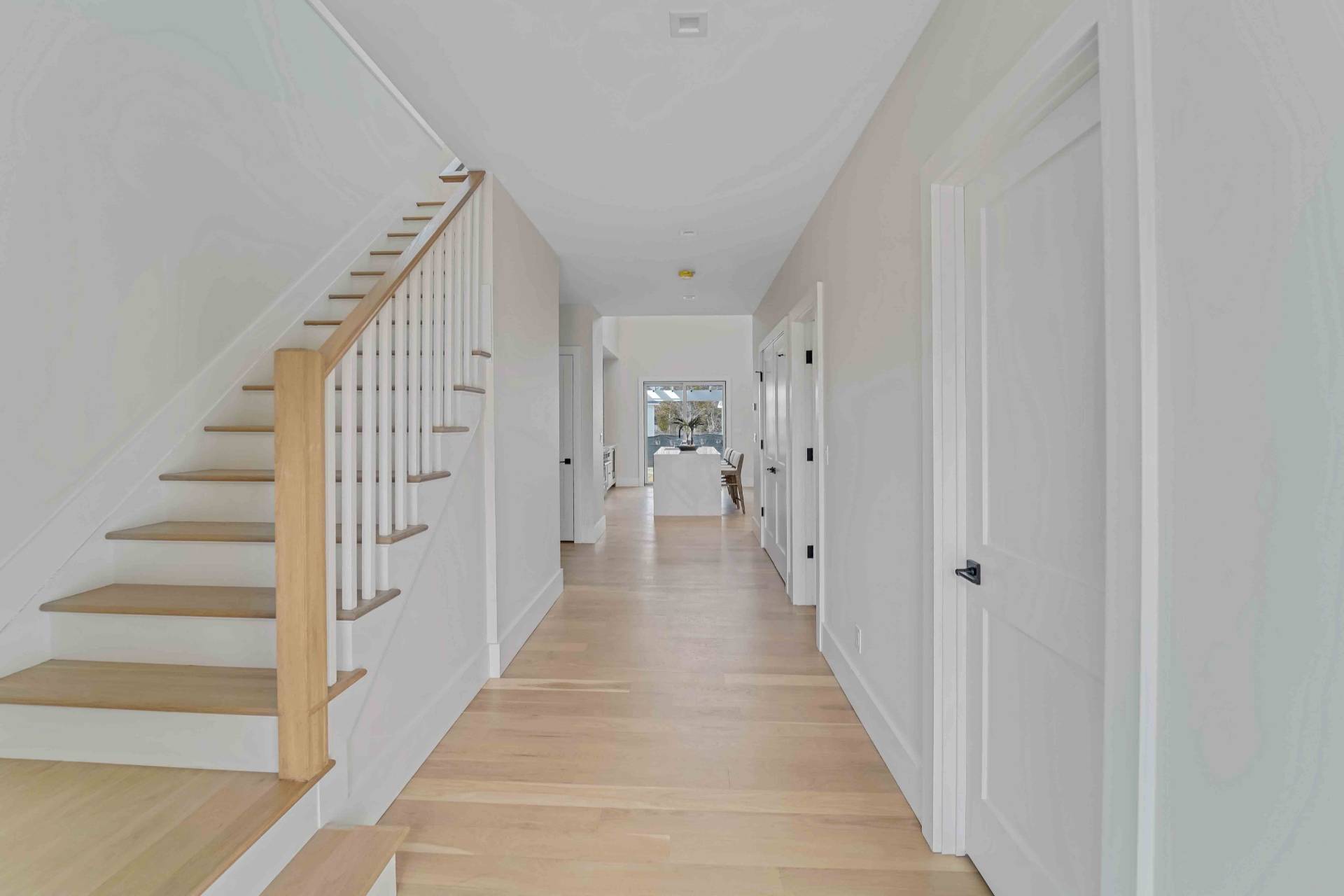 12 Depot Road, Unit 1502 Westhampton Beach, NY 11978 - Photo 11 of 26 a view of a hallway with wooden floor and entryway