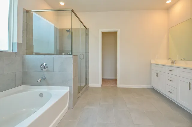 a bathroom with a bathtub and shower