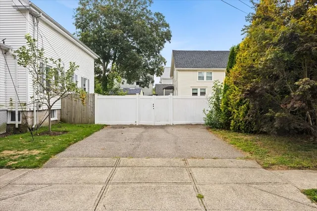 front view of a house with a yard and a garage