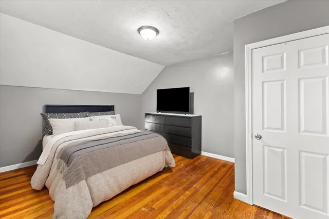 a bedroom with a bed and a tv