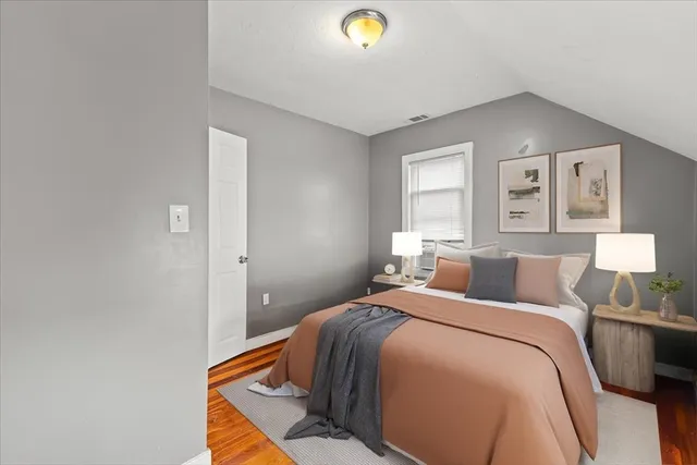 a bed room with a bed and a lamp