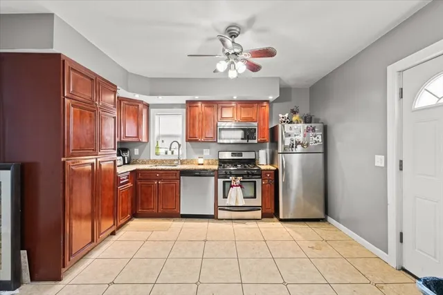 a kitchen with stainless steel appliances granite countertop a refrigerator and a sink