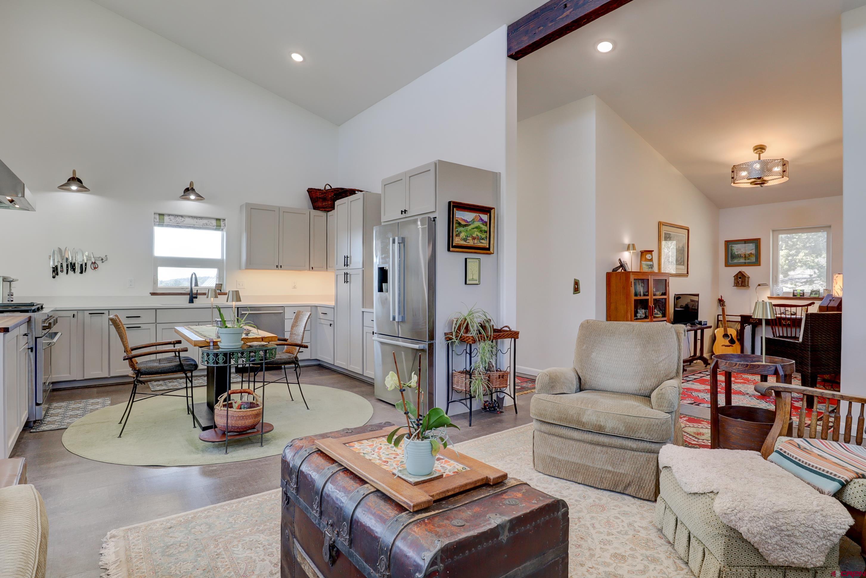 41839 Rd J.75 Mancos, CO 81328 - Photo 11 of 31 a living room with furniture and a dining table with kitchen view