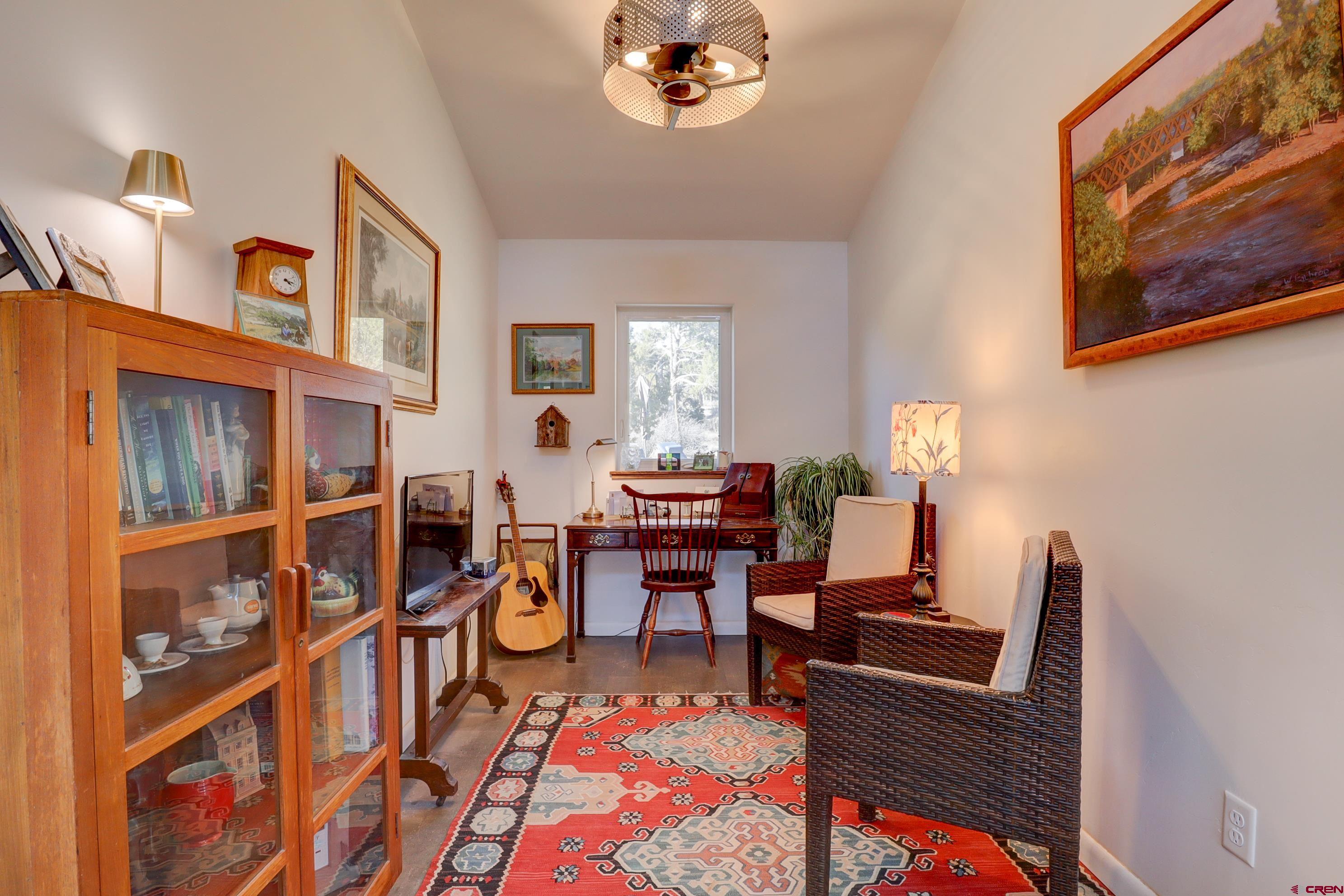 41839 Rd J.75 Mancos, CO 81328 - Photo 16 of 31 a living room with furniture a bookshelf and a window