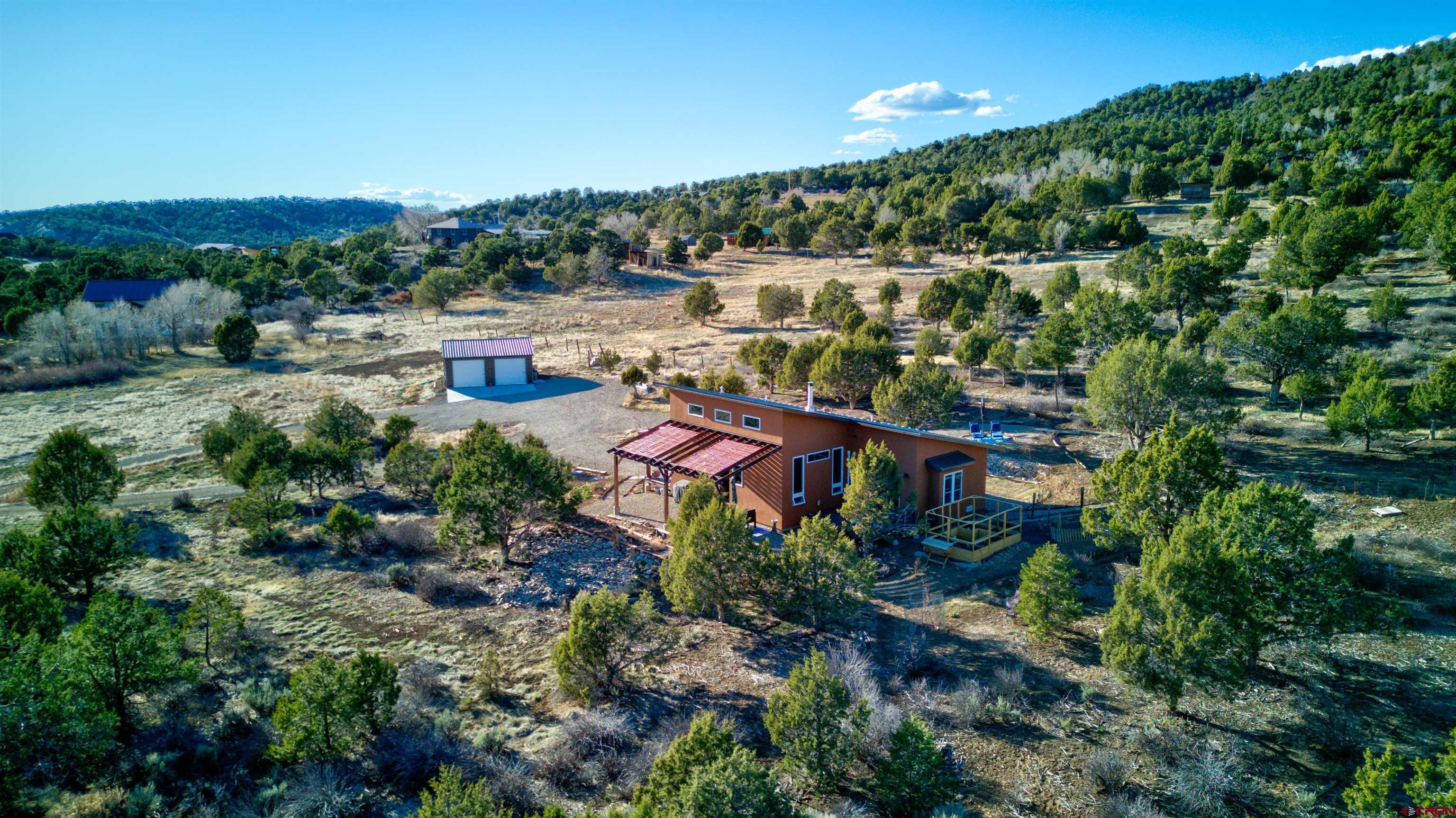 41839 Rd J.75 Mancos, CO 81328 - Photo 2 of 31 an aerial view of a house with a yard and lake view
