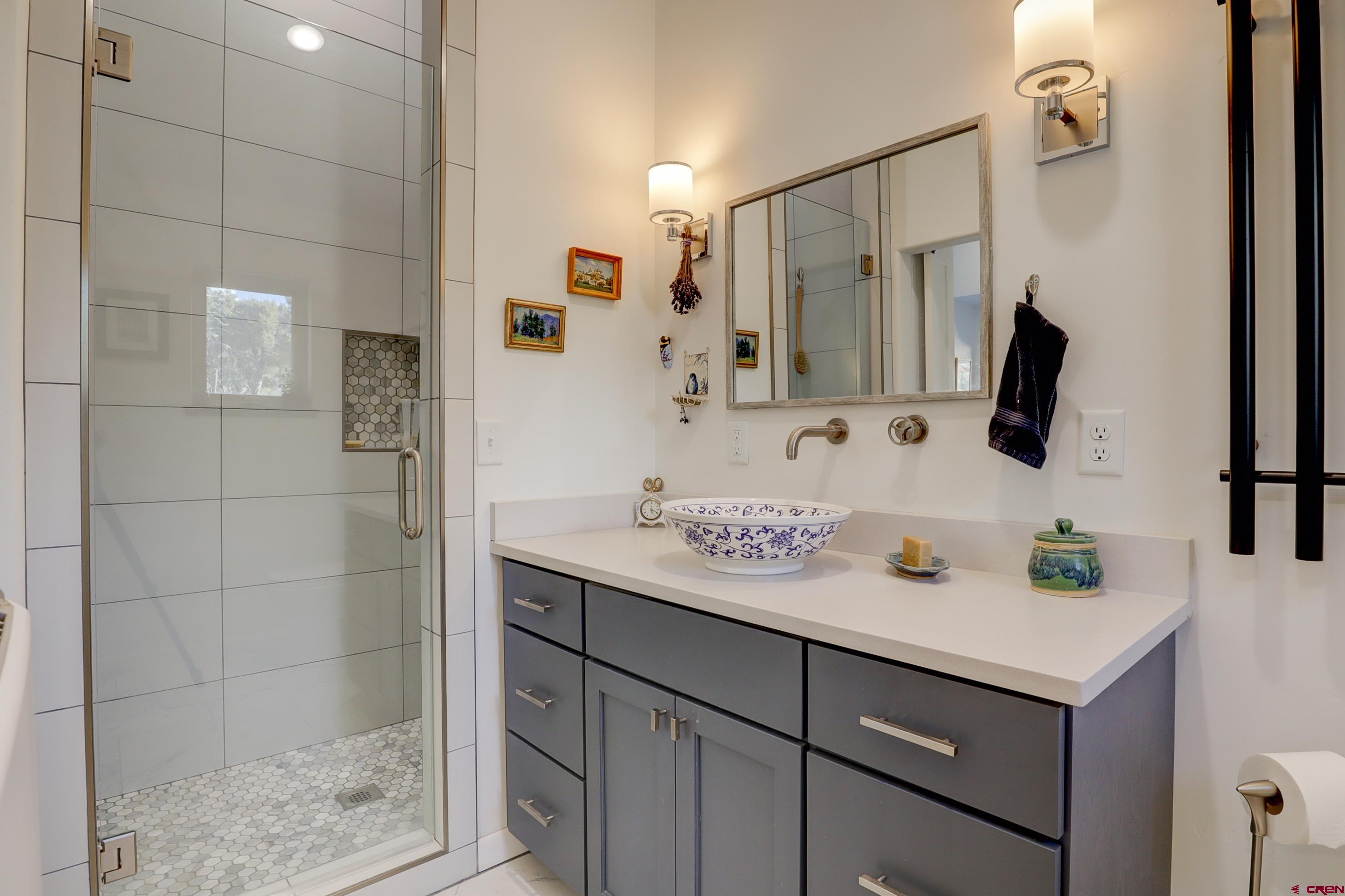 41839 Rd J.75 Mancos, CO 81328 - Photo 21 of 31 a bathroom with a sink vanity and shower
