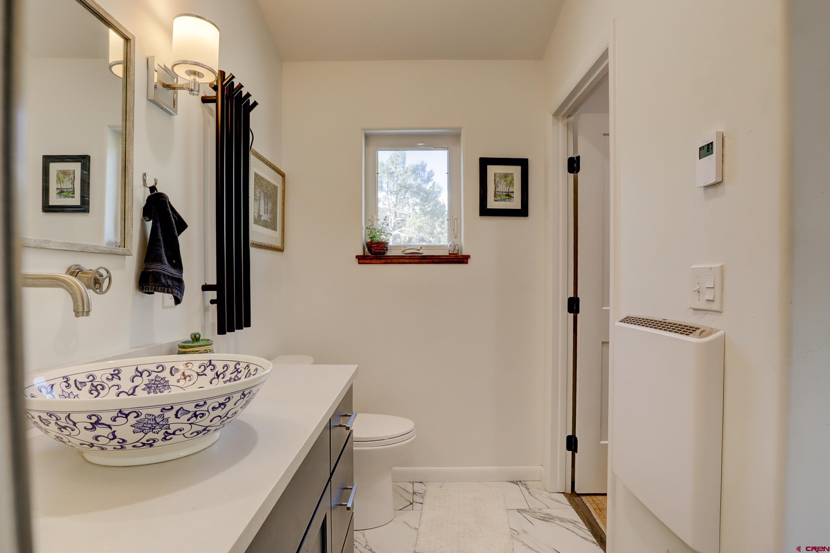 41839 Rd J.75 Mancos, CO 81328 - Photo 22 of 31 a bathroom with a toilet sink and mirror