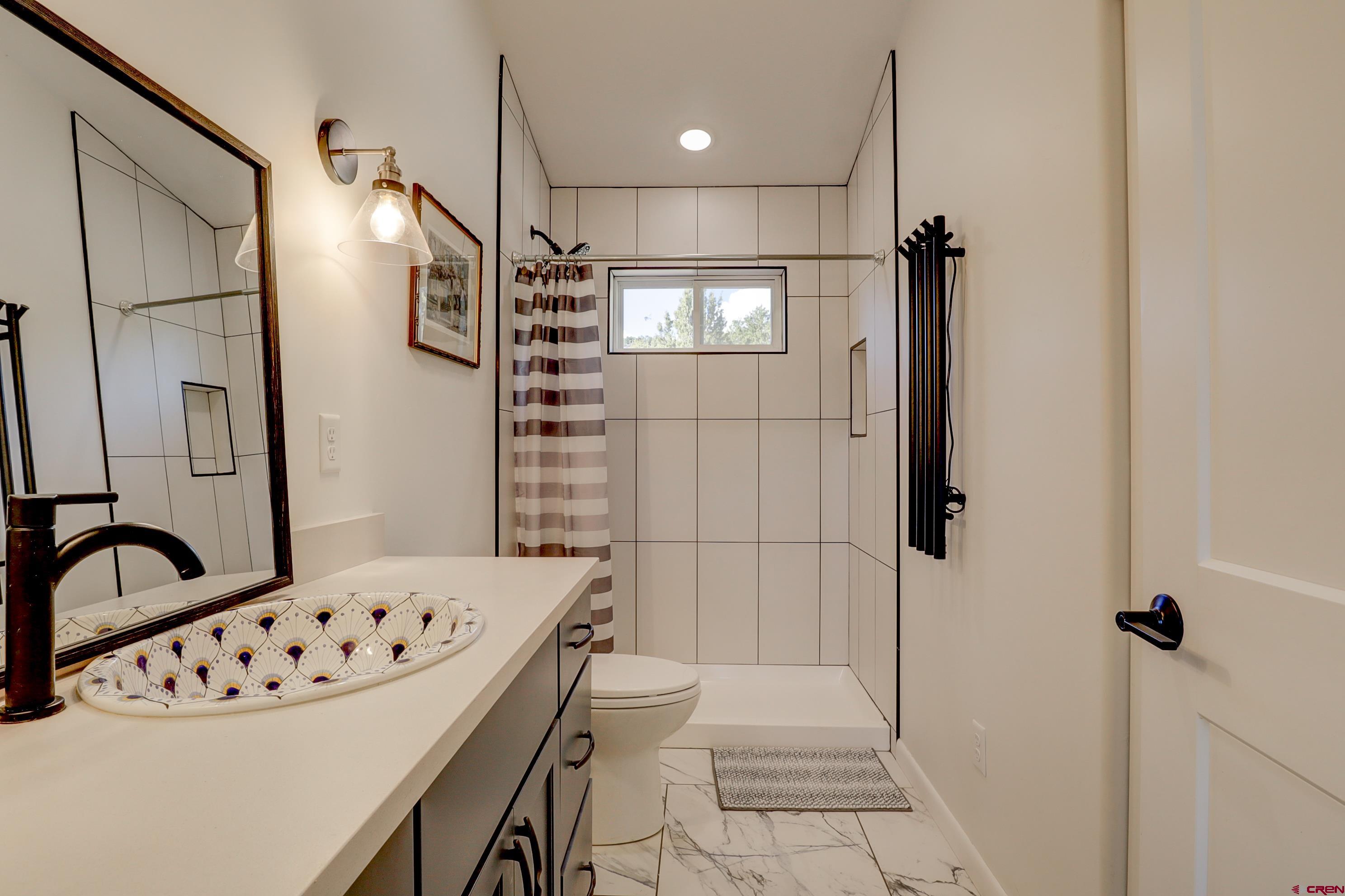 41839 Rd J.75 Mancos, CO 81328 - Photo 24 of 31 a bathroom with a bathtub and a shower