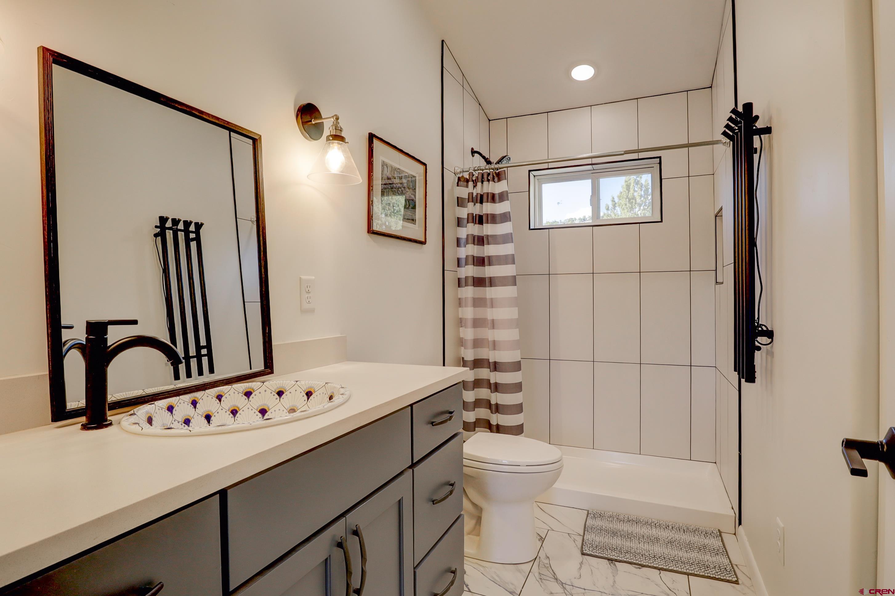 41839 Rd J.75 Mancos, CO 81328 - Photo 25 of 31 a bathroom with a sink toilet and shower