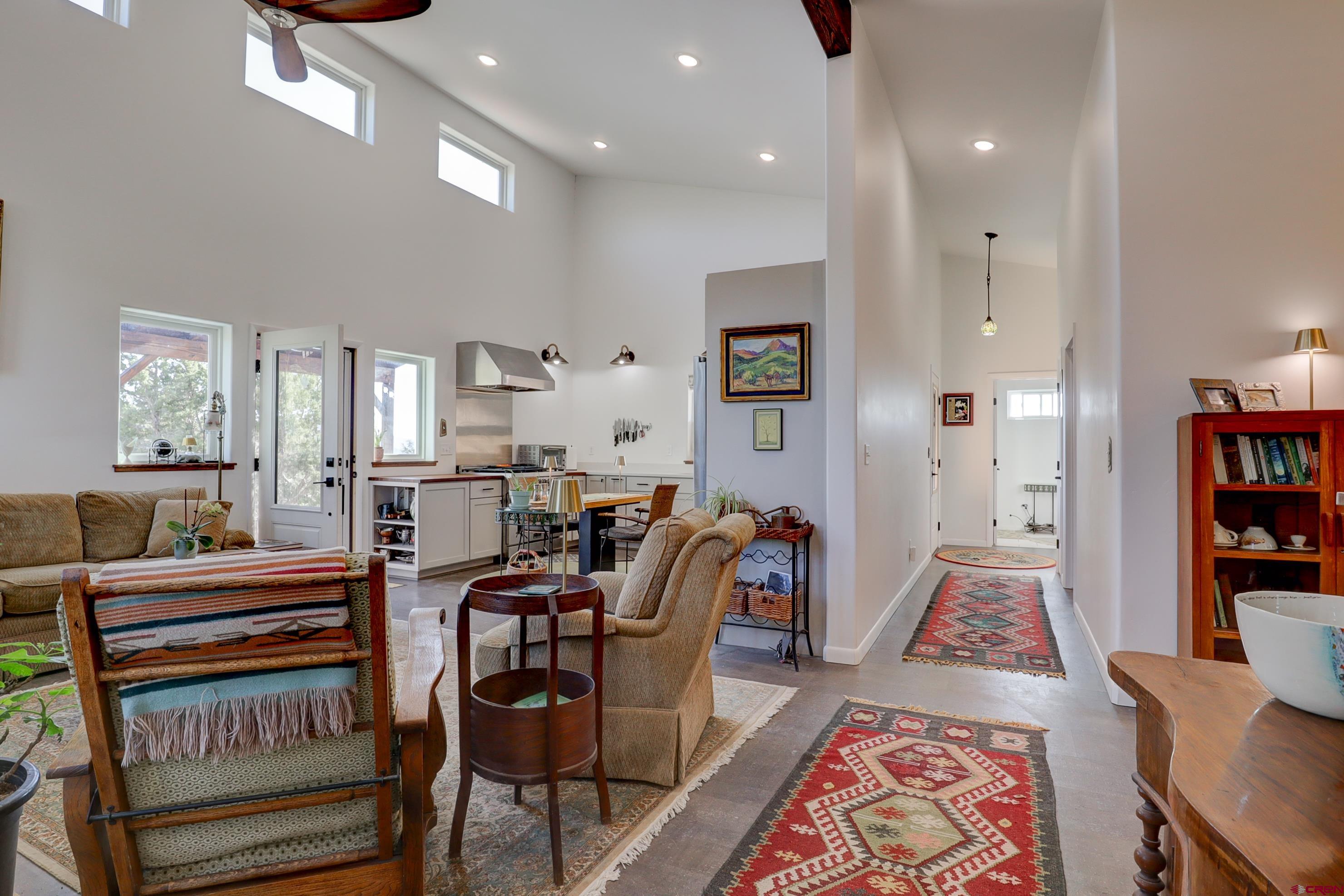 41839 Rd J.75 Mancos, CO 81328 - Photo 8 of 31 a living room with furniture a rug and a bookshelf