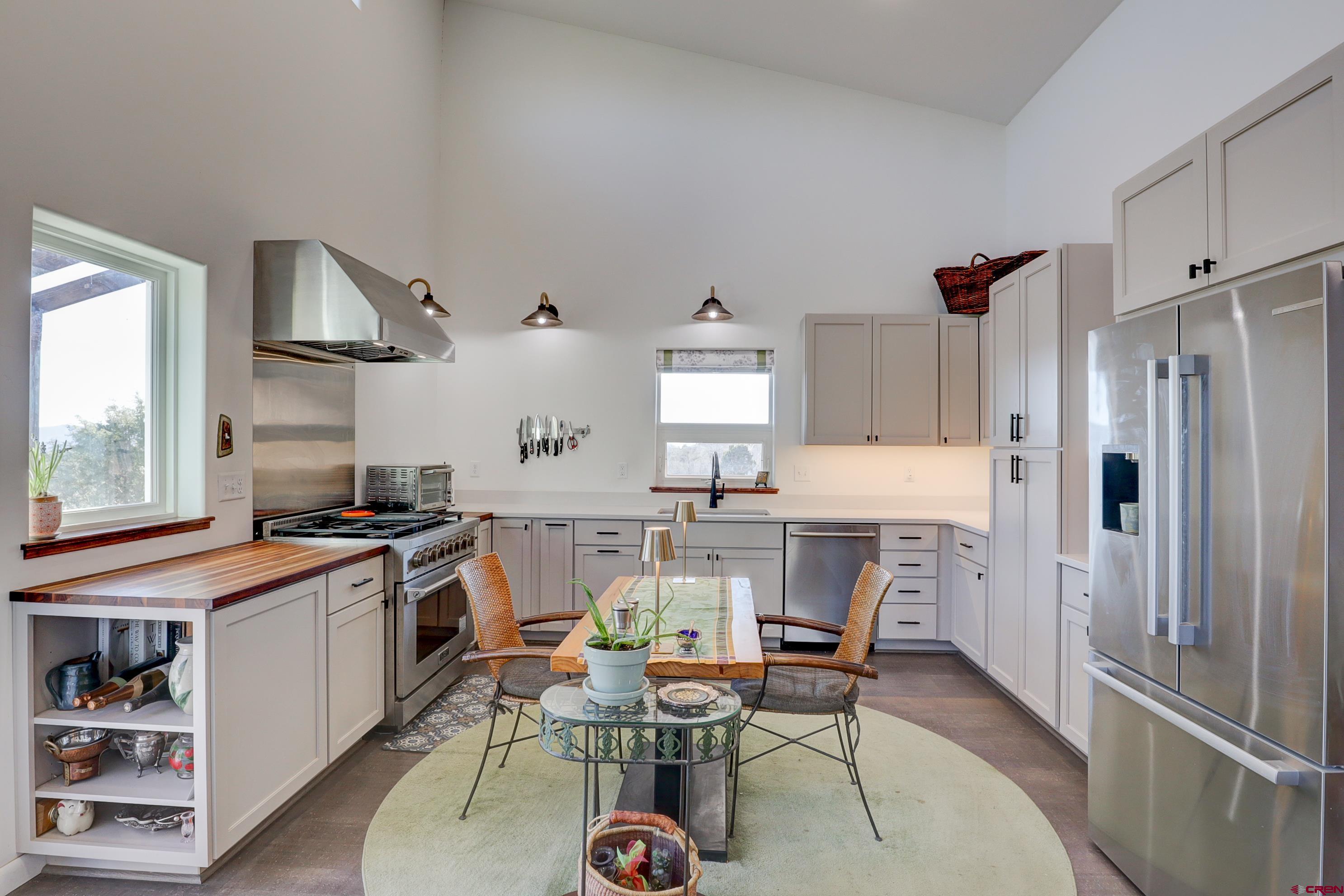 41839 Rd J.75 Mancos, CO 81328 - Photo 9 of 31 a kitchen with stainless steel appliances a stove a refrigerator and a dining table