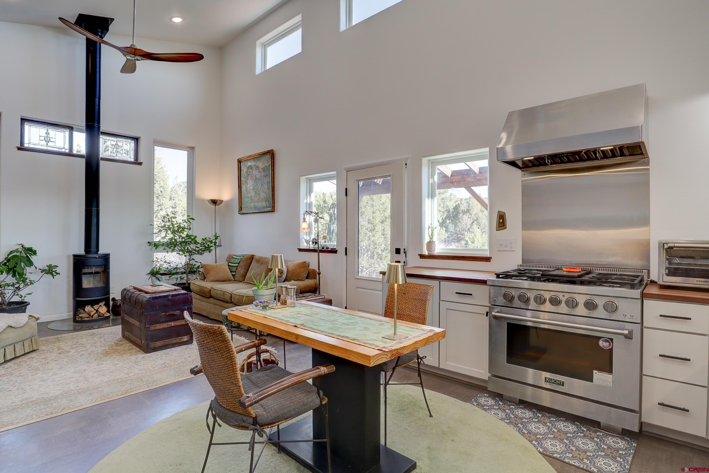 41839 Rd J.75 Mancos, CO 81328 - Photo 10 of 31 a kitchen with a stove a table and chairs in it