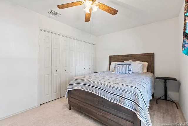 a bedroom with a bed dresser and a window