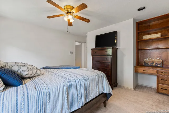 a bathroom with a granite countertop sink mirror vanity bathtub and a toilet