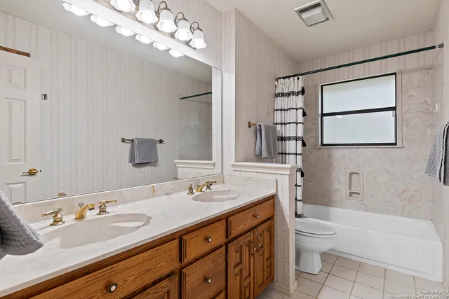 a kitchen with a sink stove and a mirror