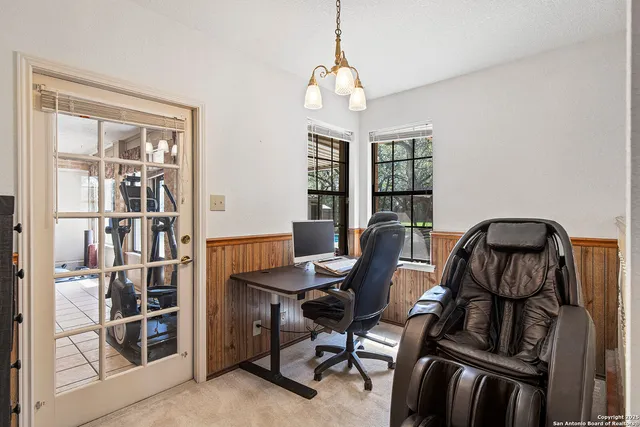 a bedroom with furniture and a flat screen tv