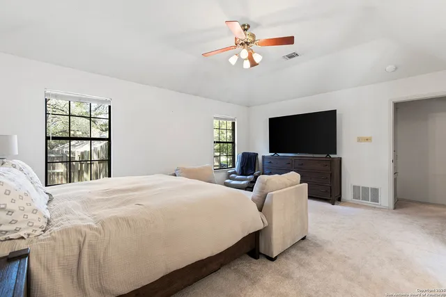 a bathroom with a double vanity sink a mirror and a bathtub