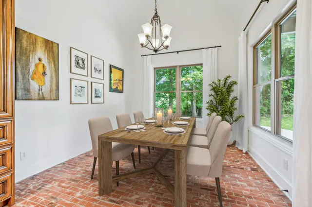 a view of a dining room with furniture wooden floor and a chandelier
