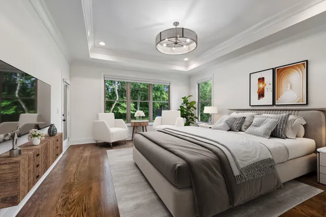 a spacious bedroom with a large bed and a chandelier