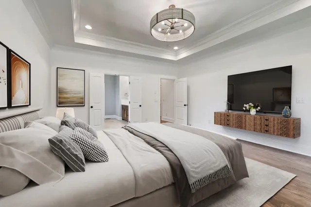 a bedroom with a bed and a flat screen tv