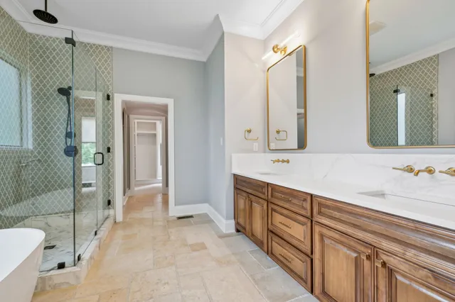 a spacious bathroom with a double vanity sink mirror and shower