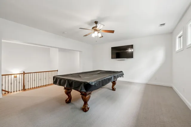 a room with pool table and a window