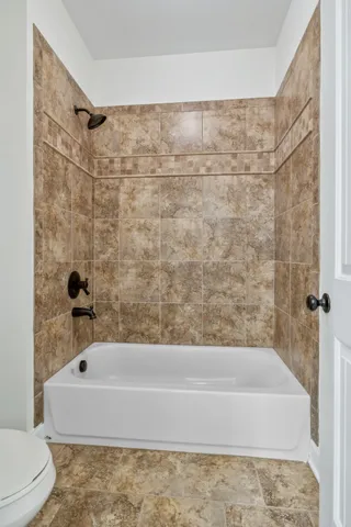 a bathroom with a bathtub and shower