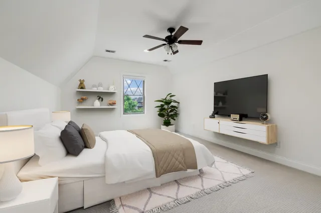 a bedroom with a bed and a flat screen tv