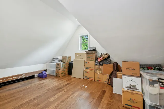 a view of a room with workspace and wooden floor