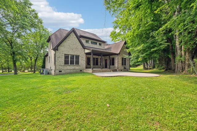 a front view of house with yard and green space