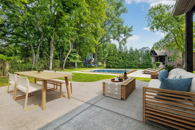 a view of a swimming pool and sitting area