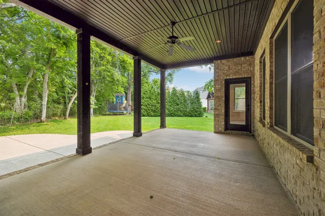 a view of a house with backyard and porch