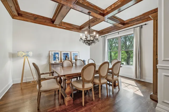 a view of a dining room with furniture a chandelier and wooden floor