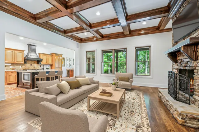 a living room with furniture a fireplace and a flat screen tv