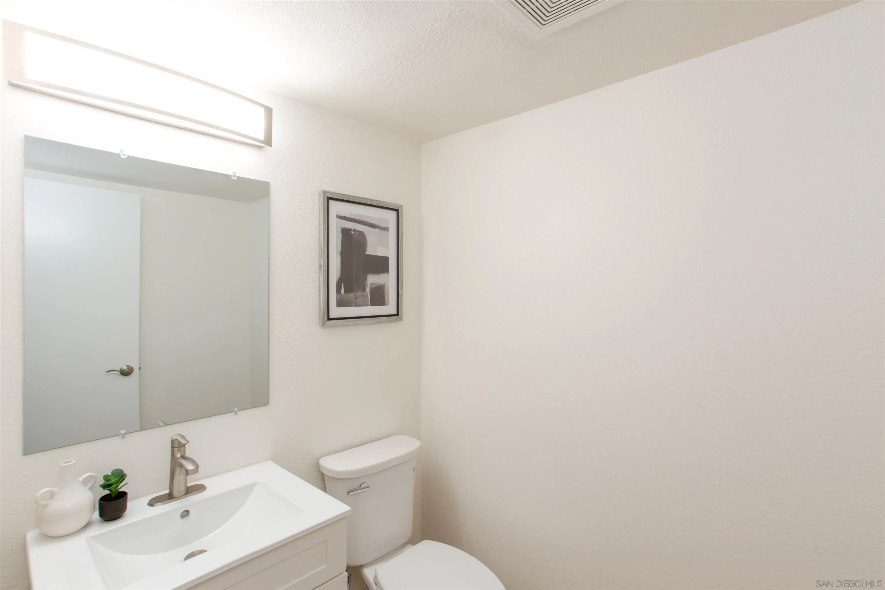 13650 Mulberry Tree Court Poway, CA 92064 - Photo 13 of 26 a bathroom with a sink mirror and toilet