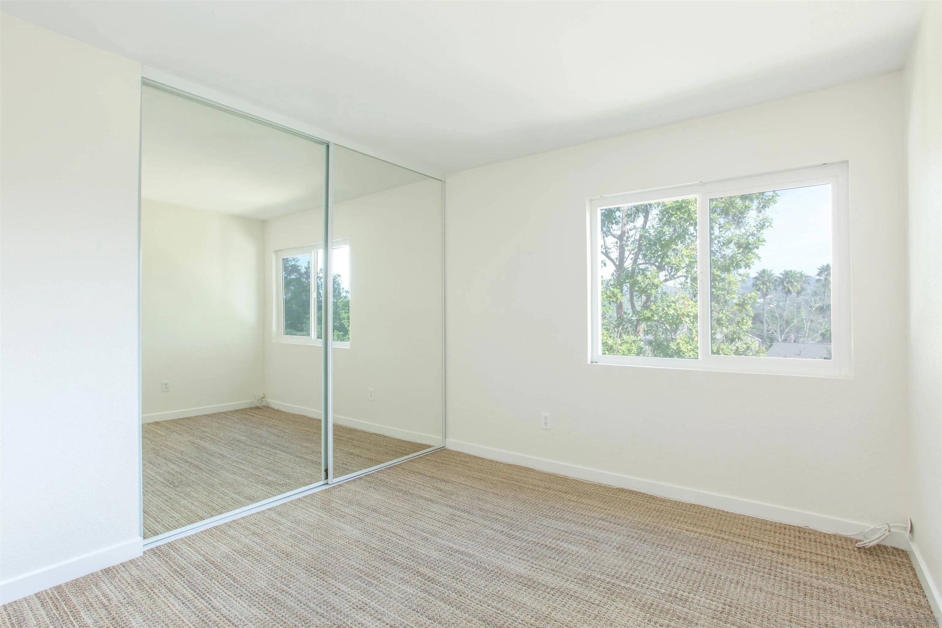 13650 Mulberry Tree Court Poway, CA 92064 - Photo 19 of 26 an empty room with wooden floor and windows