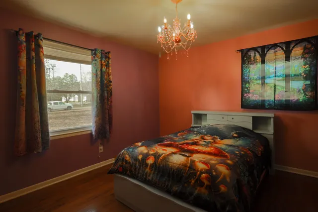 a bedroom with bed and a chandelier