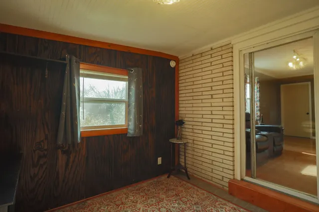 a view of outdoor space with wooden floor and windows