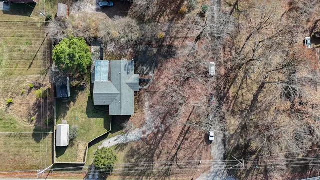 a view of a backyard with wooden fence