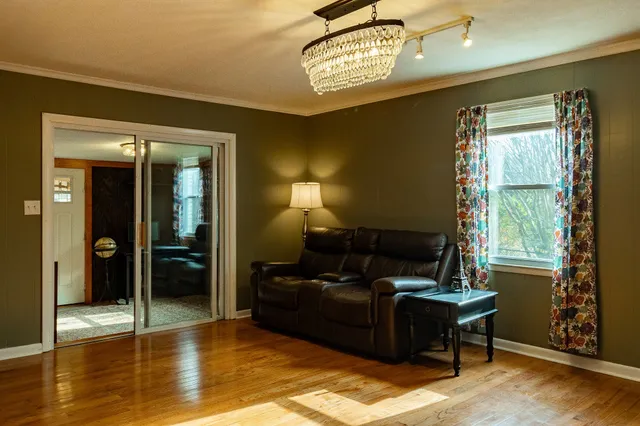 a view of a livingroom with furniture and a chandelier