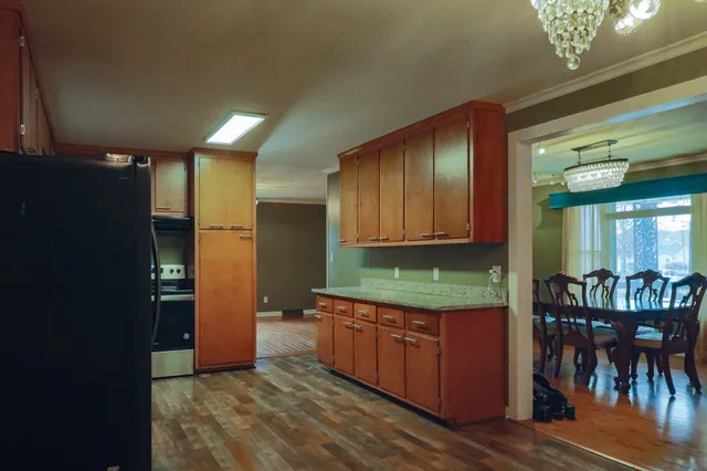a kitchen with stainless steel appliances granite countertop a refrigerator and a sink