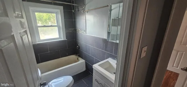 an empty room with wooden floor and closet