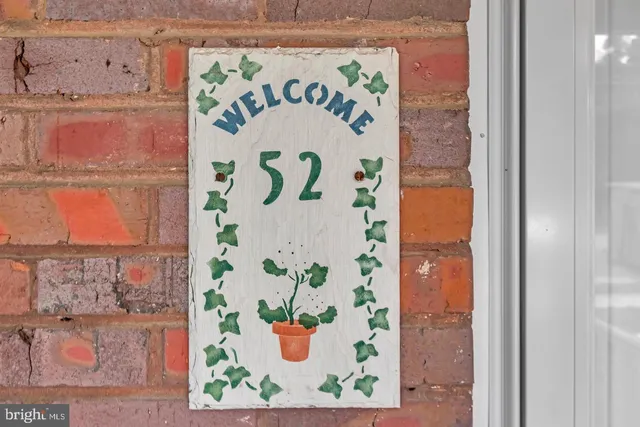 a view of empty room with fireplace and wooden floor