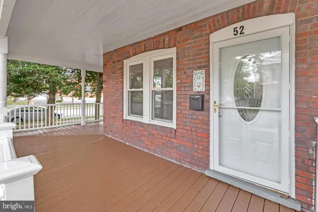 an empty room with windows and fireplace