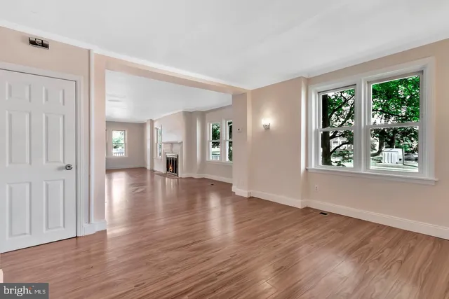 a kitchen with granite countertop white cabinets a sink a window and stainless steel appliances
