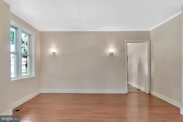 an empty room with closet and windows