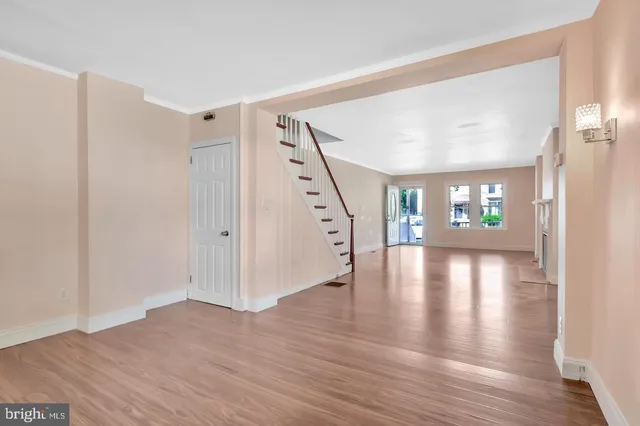 a view of an empty room with wooden floor
