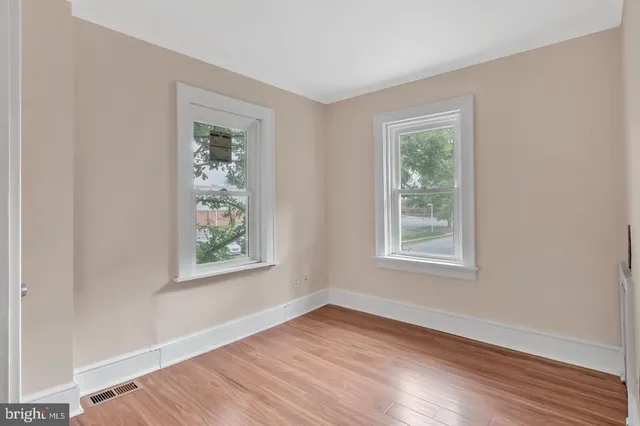 a view of a deck with chairs and a yard with wooden floor