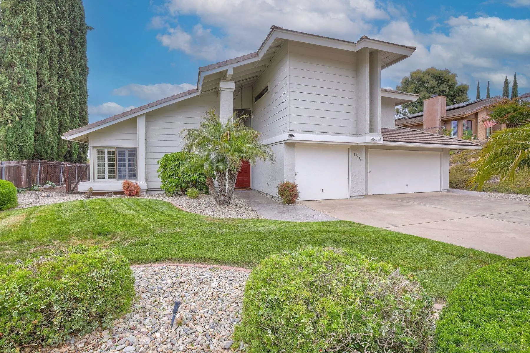 a view of backyard of house with outdoor seating and green space